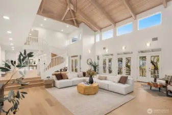 Grand in scale and design—25’ wood-beamed ceilings with twin 84” fans, a reclaimed timber mantel illuminated by remote-controlled LED lighting, and four double doors that open seamlessly to a 65’ veranda.