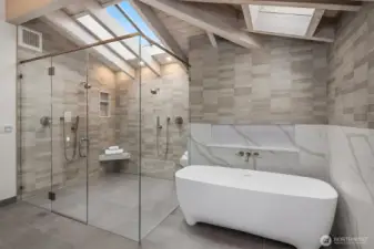 A true spa retreat—smooth, continuously heated floors tapered to a wall drain, a sculptural solid-stone soaking tub, dedicated gas hot water, and LED-accented defrosting mirrors.