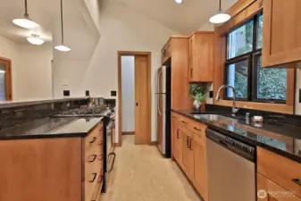 Beautiful granite slab countertops and natural wood cabinets.