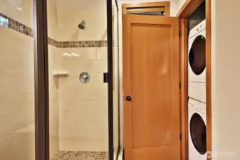 A stacked washer and dryer in the main floor bathroom.