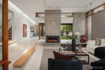 The architecturally significant design feels in constant conversation with its surroundings—pure lines, rich natural light, and quietly exquisite craftsmanship in every detail, including kerfed (trimless) doors, windows, and baseboards throughout, custom built-ins, expansive skylights, and a floating staircase that reads like functional sculpture.