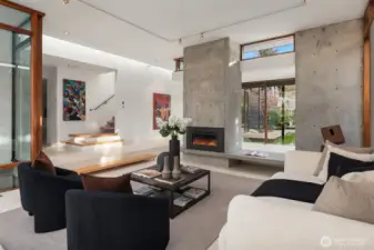 A sculptural concrete fireplace with an extended bench hearth