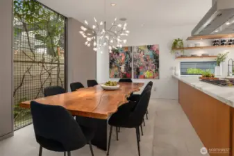 The “green window”: A signature design element—metal grid cladding supports  evergreen clematis for privacy while filtering light into the dining area, creating a living  screen that changes with the seasons.