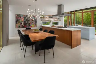 Kitchen to garden: Expansive doors open to the patio and yard, with the detached guest  suite hovering above the garage beyond—an elegant blend of function and form.