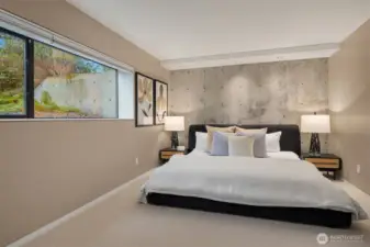 Both lower level bedrooms feature concrete walls, views out to nature and are spacious in size