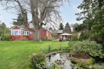 This property has tons of extra features adding to the private, secret garden effect while still feeling open and exposed to the incredible western views of the Puget Sound and Olympics; 2 gazebos, pond, playhouse, large garden shed, rope swing, and more.