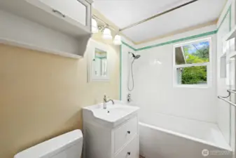 EVERYTHING in the bathroom has been tastefully updated and the tub features a tiled surround. Although not shown in this photo, the oak hardwood flooring is beautiful!
