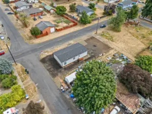 Aerial view of this beautifully upgraded 5,000 SF lot in Bucoda—featuring a brand-new 1,296 SF manufactured home, freshly planted lawn, and two convenient gravel parking spots. A perfect blend of space, function, and curb appeal from above.