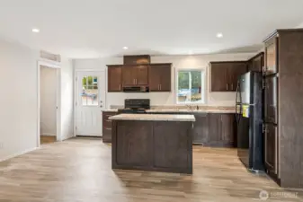 There is a laundry room to the left of the kitchen.