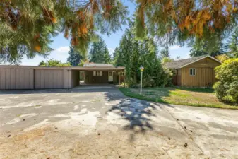 Covered parking for 2 under carport, enclosed shop with room for 1 car possible. RV parking and additional driveway parking