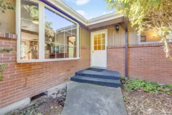 Home features brick and cedar siding which welcomes you into the main door of home