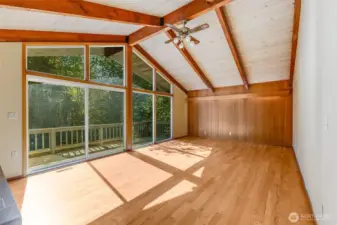 Large living room is open and bright, hidden accent lights behind wood trim