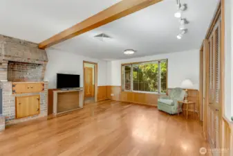 Family room has great lighting, beams and bench seats. The brick details have an original area for indoor grilling, now converted to a cabinet