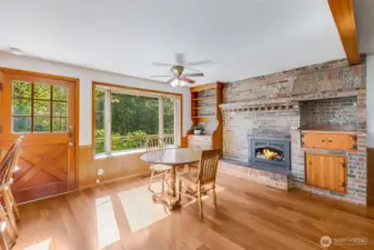 Gas fireplace insert and built-in shelving and cabinet feature in dining area