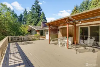 Back patio, has built-in bench and leads to primary, kitchen/dining and living room