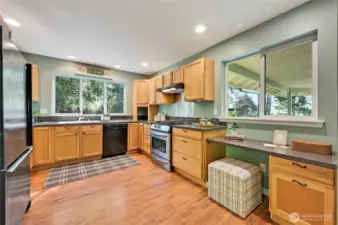 Enjoy peaceful outlooks of evergreens while standing at the kitchen sink. Peak-a-boo water views to the south.