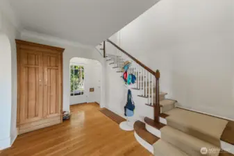 Unit B entry way with built in coat closet, new carpet on stairs.