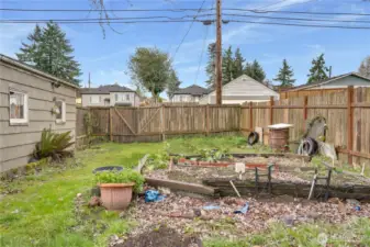 A fenced yard with space for a garden or expansion.