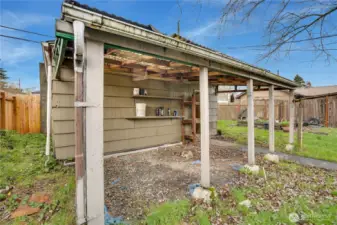 Covered outdoor workspace attached to the garage.