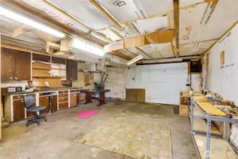 Garage includes a workbench and cabinets—perfect for a workshop setup.