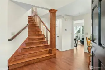 And once you're inside, you're greeted by a beautiful staircase, and expansive cherry hardwood floors.