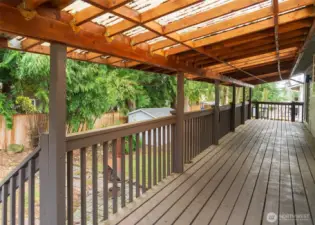 A covered deck overlooks the back yard, with slider access from either the dining room or the main bedroom.