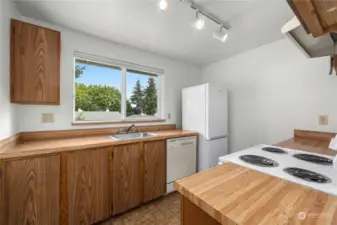 Great sized kitchen with neutral cabinetry and a sink situated under a large window allowing more natural light.