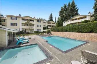 Community features an outdoor pool/hot tub area, athletic courts and surrounded by beautiful tall trees.