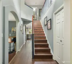 You can see the kitchen at the very end of the hallway.  Stairs to second level.  All bedrooms and bonus room/office are on the second floor. Beautiful flooring and finishes throughout.