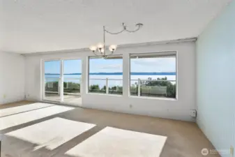 Living room and dining area with a million-dollar view! The unit could use new flooring and paint to freshen it up.