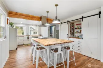 Custom built in storage with dual barn door pantry provides all the storage you'll need in this huge and inviting kitchen.