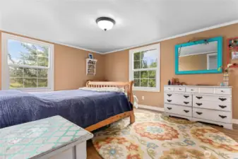 Upstairs the primary bedroom is generous in size with a walk-in closet and beautiful windows looking out to the front and sides of the property.