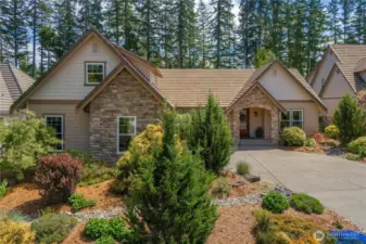 Thoughtful and meticulous landscaping spans the entire property, lush, vibrant, and lovingly maintained by original owners