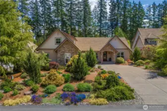 Long private driveway leads  to a large two-car garage, offering plenty of space for guests or extra vehicles