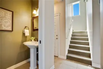 Half bath on main for guests and upstairs to the bedroom suites and view deck