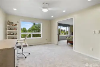 This spacious upstairs loft offers endless possibilities, serving as a comfortable retreat, media room, or home office. Large windows frame breathtaking views of the lush ravine, allowing natural light to fill the space while creating a serene atmosphere. Neutral tones and modern finishes enhance the room’s versatility, while open-concept design ensures seamless flow. Whether used for relaxation, entertainment, or productivity, this bonus area provides both functionality and a stunning backdrop.