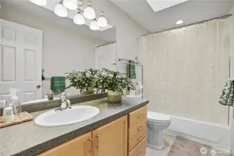 A polished full bath with a sleek vanity and modern lighting, providing both style and functionality.