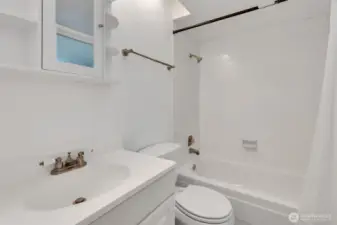 Full bath serving bedrooms two and three on upper level.