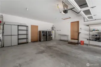Two car garage with with high ceilings and lots of storage opportunities.