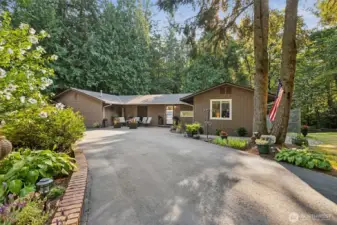 Rare rambler retreat on Tiger Mountain! Nestled on a shy acre of completely flat land, this home offers a peaceful lifestyle enhanced by a seasonal creek and over 1,400 sq ft of wraparound decking to relax and entertain while enjoying the tranquil sounds of water and nature. Used to be a B&B! No restrictions on rentals in this area.