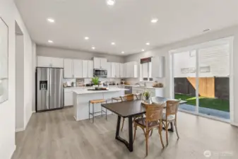 Large kitchen with soft close doors on shaker style cabinets. Photo is representational. Actual home is under construction and colors, materials, and finishes may vary. See site agent for details.