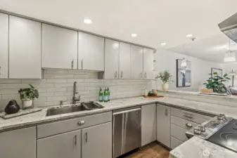 Beautifully Updated Kitchen with Quartz Counters, Tile Backsplash, and LVP Flooring