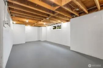 Former owners’ basement workshop with ample lighting, good ceiling height, a window, and updated electrical.