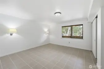 More generosity in size for this lower level bedroom. That sliding door on the right is the closet.