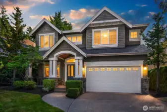 This stunning John Buchan craftsman home offers exceptional curb appeal with its rich stone accents, cedar shingle detailing, and lush mature landscaping set on a quiet cul-de-sac. The welcoming covered entry, three-car tandem garage, and beautifully manicured grounds make a lasting first impression.