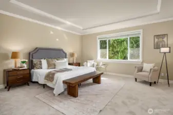 The massive primary suite is a true sanctuary, featuring a elegant tray ceiling, plush carpeting, and a serene neutral palette that creates an atmosphere of effortless luxury and relaxation. A beautiful window bench seat bathes the room in natural light while offering a peaceful retreat to unwind at the end of the day.