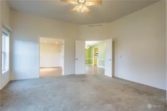 Primary bedroom looking towards attached bonus room/office and dining room