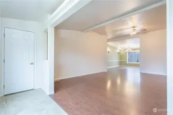 Front entry and closet, looking towards one living room and dining room