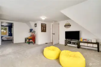 This open and spacious bonus room connects the two upstairs bedrooms. What a great place to relax, play games, or watch a movie. New carpet was installed just a few years ago!