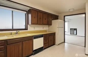 The kitchen with Harbor Views is open to the dining room.